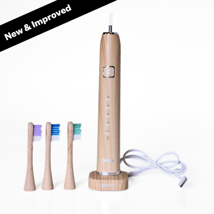 etee electric toothbrush with replaceable bamboo head standing up with text "new and improved"